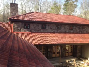 Brava Spanish barrel tile roofing installed by Certified Roofing on a stone and stucco home